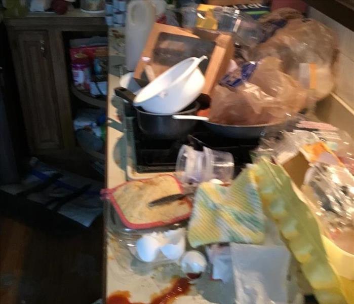 Counter top full of old food and garbage