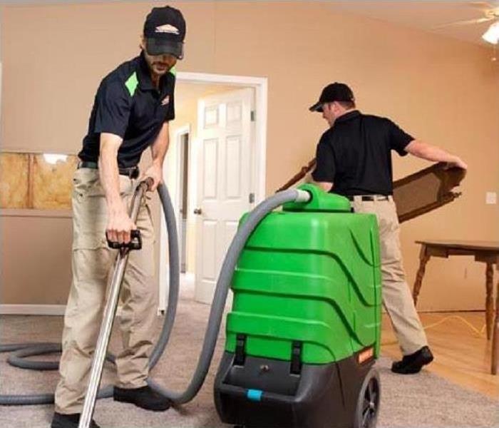 Water Damages to your Home or Business? - Image of technicians cleaning a home