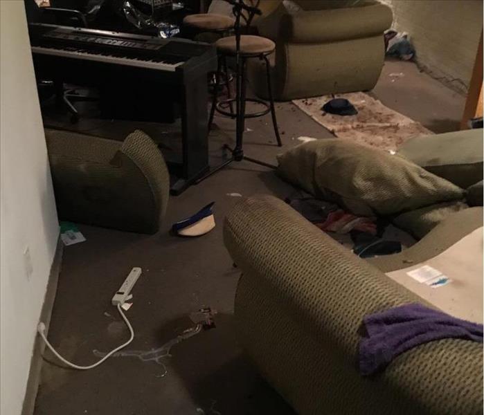 family room with couch piano and debris on floor